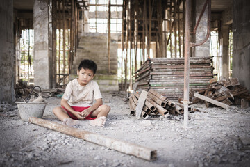 Two poor children are forced to work in construction. Poor children, poverty, Child labor, World Day Against Child Labour concept.