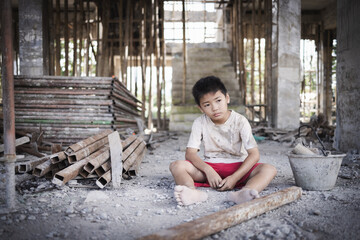 Poor children are forced to work in construction. Child labor in building commercial building...