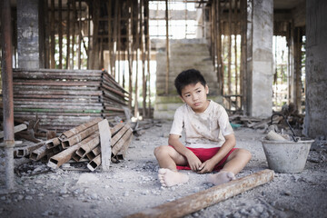 Poor children are forced to work in construction. Child labor in building commercial building structures. World Labor Day concept.