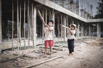 Two poor children are forced to work in construction. Poor children, poverty, Child labor, World Day Against Child Labour concept.