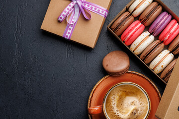 Coffee and colorful macaroons in gift box