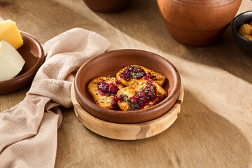 Family Dinner: Middle-Aged Caucasian Woman Serves Fried Cheese with Lingonberry Jam in Rustic Kitchen Setting at Evening