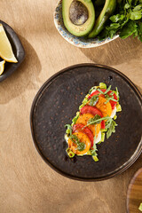 Young Woman Preparing Caprese Salad with Tomato, Mozzarella, and Avocado in Modern Kitchen During Lunchtime