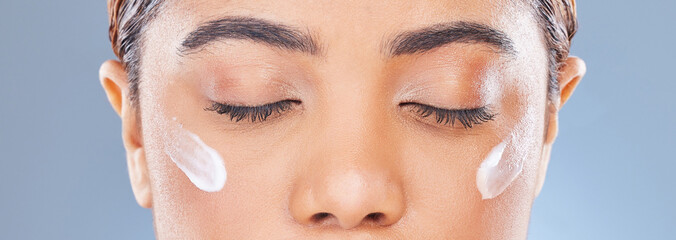 Eyes, cream and woman with dermatology, beauty and cosmetics on a white studio background. Face,...