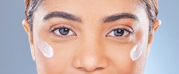 Face, cream and woman with dermatology, beauty and cosmetics on a white studio background. Eyes,...