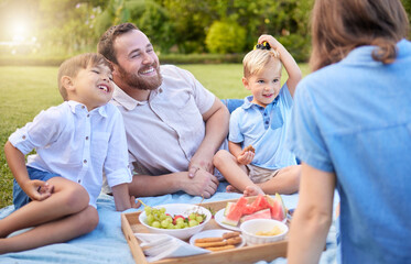 Mom, dad and kids picnic in park for weekend bonding, eating and happy family on grass together....