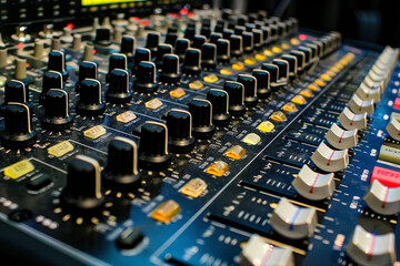 Obraz premium Audio mixing console with rotary controls, sliders, and buttons 