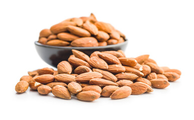 Peeled almond nuts in bowl isolated on white background.