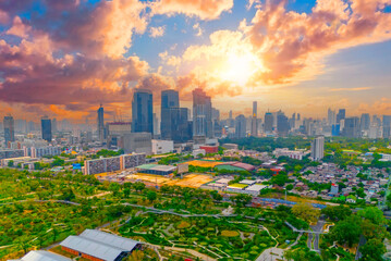 Benchakitti forest park is new cityscape landmark public park, aerial sunset view picturesque dawn clouds sky.