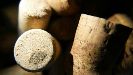  Close-up shot of wine corks. Several wine corks in a bowl. Wine stopper in a jar. Wine cork in...
