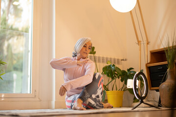 Senior Woman Practicing Yoga at Home with Ring Light