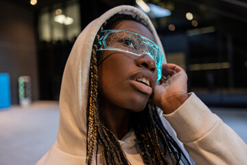 Futuristic Young Woman in Neon Glasses and Hoodie