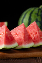Slices of fresh watermelon on the rustic wooden table