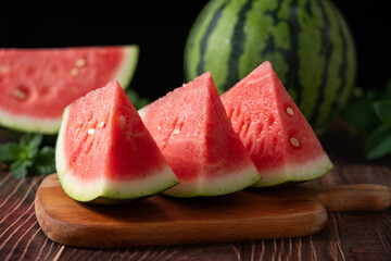 Slices of fresh watermelon on the rustic wooden table