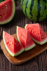 Slices of fresh watermelon on the rustic wooden table