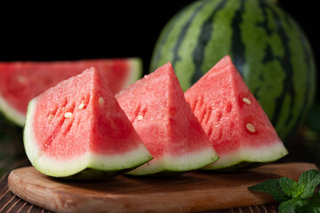 Slices of fresh watermelon on the rustic wooden table