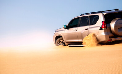 Close up of a golden car stuck in the sand in the Namib desert.