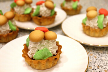 Cake basket with mushrooms. Cake mushrooms white cream on white plate. Homemade mushroom-shaped cookies. Bakery sweet cake basket with mushrooms.