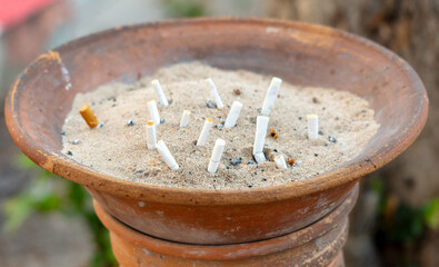 Cigarette butts in a sand bin