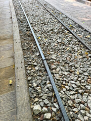 Naklejka premium A railway strewn with stones as a background