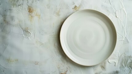 empty white plate on a distressed concrete background