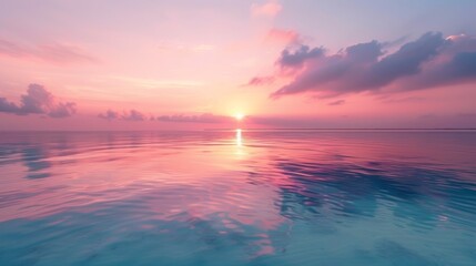 Obraz premium A serene photo of a pink sunset over a calm ocean, reflecting the soft hues of the sky onto the water's surface.