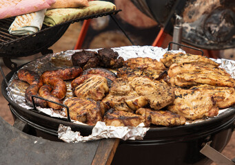 grilled meat on coals as a background.
