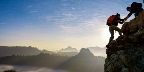 Asian hiking help each other on mountains