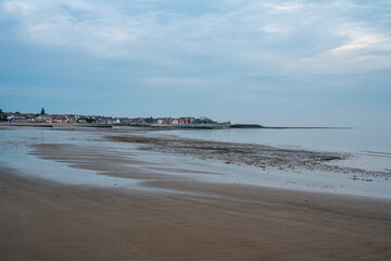 Rhos-on-Sea empty beach and seafront at low tide.