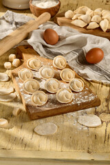 Pelmeni on a wooden board, a rustic scene showcasing Slavic culinary traditions