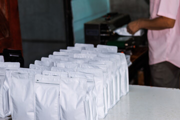 white coffee bag in a row, package process for shipping and retail.
