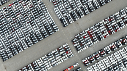 aerial top down view of a parking lot new cars lined up in the port for import and export...