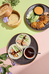 Elegant Peking duck rice pancakes with hoisin sauce, perfect for a sophisticated restaurant menu