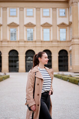 Portrait of beautiful caucasian woman wearing coat is walking by Wien street.