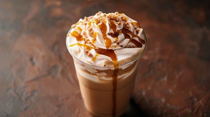 Overhead view of iced coffee with whipped cream peak and caramel sauce, isolated background, studio lighting
