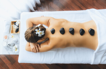 Panorama top view hot stone massage at spa salon in luxury resort with day light serenity ambient,...