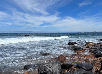 Atlantic ocean view from a rocky beach in south of Tenerife, canary islands. Horizon over sea and blue sky. Vacation, tourism, travel destination