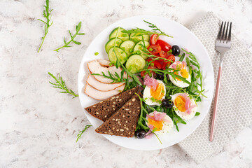 Healthy breakfast. Boiled egg, chicken ham, bread and fresh salad. Keto breakfast. Top view, overhead