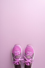 Workout prep kit. Vertical top view of female gym trainers on pastel purple background with space for text or advert