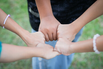 Closeup of diverse people holding hands