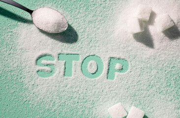The German word Stop written with sugar on a turquoise background