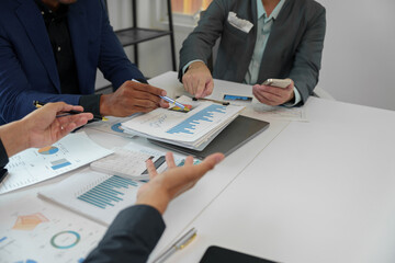 Business idea. Business people talking And calculations about charts and graphs showing the growth of investment results Of successful teamwork.