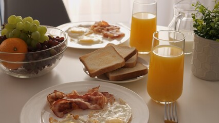 An American breakfast with eggs is on table. Scrambled eggs, sunny side up, scrambled eggs is celebration of egg dishes. Ideal for showcasing the variety of egg breakfast options in American cuisine.
