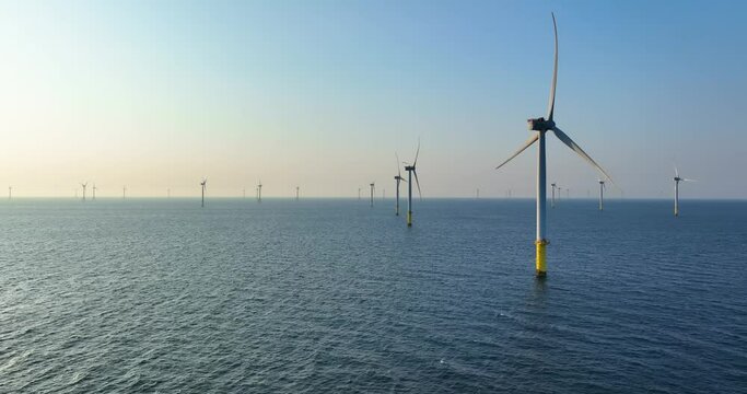 Wind turbine field over the sea in the evening