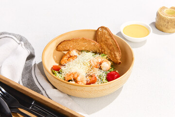 Caesar Salad with Shrimp and Parmesan in Wooden Bowl