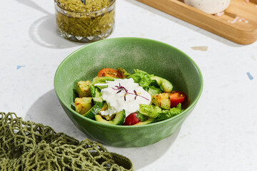 Fresh Vegetable Salad with Stracciatella Cheese and Pesto Sauce in Green Bowl