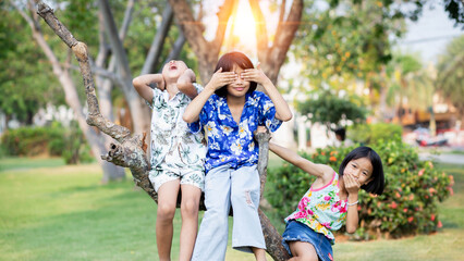 Fototapeta premium Children play in the summer sunny garden