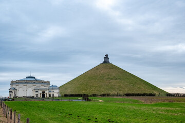 This photograph depicts the Lion's Mound with its imposing lion statue overseeing the grounds,...