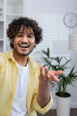 Smiling man making a video call from home, engaging in conversation