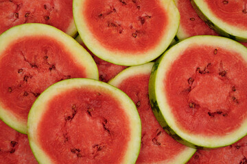 Summer fruit background concept, close up of a pile of red round watermelon slices as summer fruit...